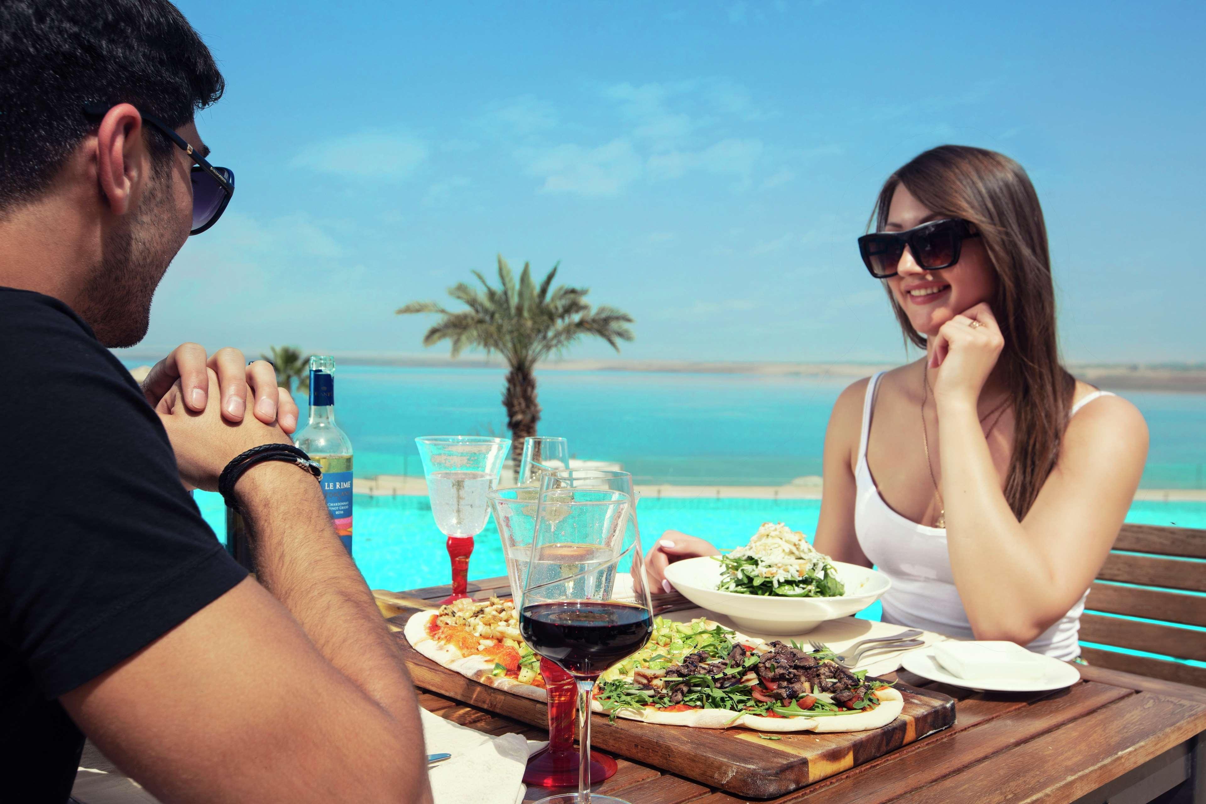 Hilton Dead Sea Resort & Spa Sweimeh Exterior photo A couple dining at a restaurant