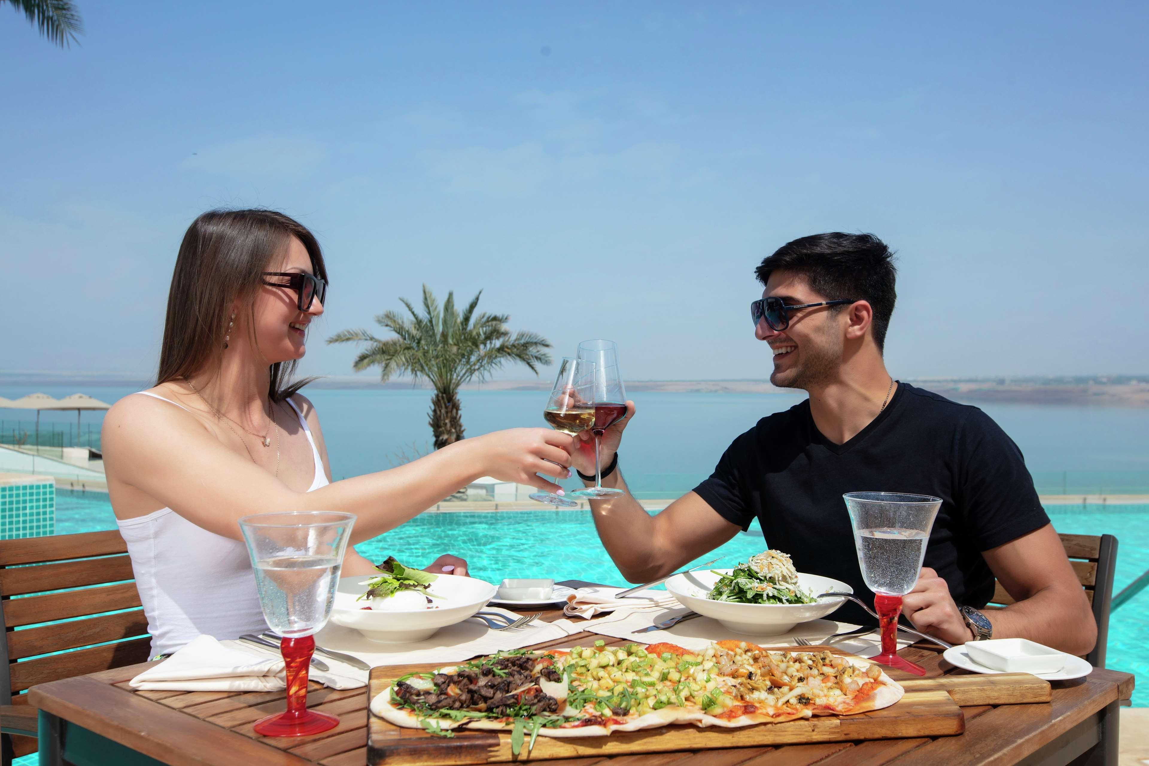 Hilton Dead Sea Resort & Spa Sweimeh Exterior photo A couple dining at a resort